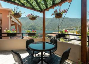 a table and chairs on a balcony with a view at Summer retreat in Kotor