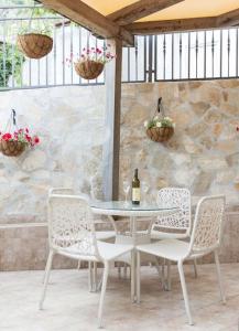 a table and chairs with a bottle of wine at Summer retreat in Kotor