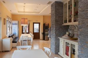 a kitchen and living room with a brick wall at Къща за гости Пилигрим in Skrino