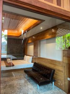 a living room with a couch and a bed at Krabi Klong Muang Bay Resort in Klong Muang Beach