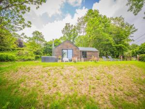 a house on a hill with a yard at Holiday home 'Be Chalet' in the heart of nature in Ferrieres in Ferrières