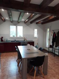 a kitchen with a table and chairs in a room at maison de campagne au calme in Chuelles +22 photos