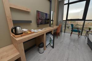 a room with a desk with a television in a room at MİLLS HOTEL in Tekirdag