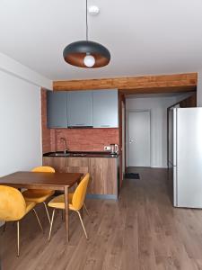 a kitchen with a table and chairs and a refrigerator at Apartment with a great view 544 in Gudauri