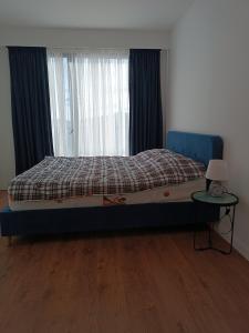 a bedroom with a bed and a table and a window at Apartment with a great view 544 in Gudauri