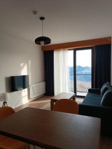 a living room with a couch and a table at Apartment with a great view 544 in Gudauri
