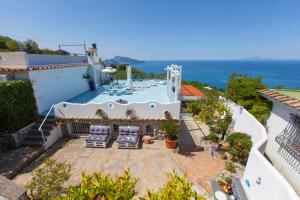 a house with a swimming pool and two chairs at Villa Venus in Penisola sorrentina in Massa Lubrense
