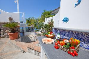a table with a basket of vegetables on it at Villa Venus in Penisola sorrentina in Massa Lubrense