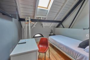 a bedroom with a bed and a desk and a chair at Hotel Parada Puigcerda in Puigcerdà