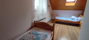 a small room with two beds in a house at Domek na Malinowej in Szczyrk