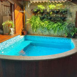 a swimming pool in a house with plants at Casarão Paraty in Paraty