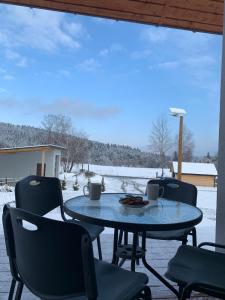 a table and chairs on a patio in the snow at Na wilczym szlaku in Ustrzyki Dolne