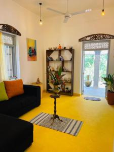 a living room with a couch and a table at Birdsong Villa in Rathgama