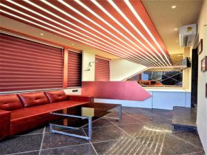 a living room with a couch and a table at Hotel Rose Gold in Ahmadnagar