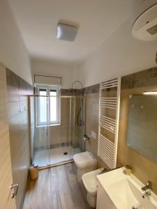 a bathroom with a shower and a toilet and a sink at Da Enza in Taranto +30 photos