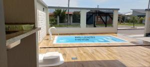 Πισίνα στο ή κοντά στο Casa Com Piscina Pertinho Do Mar Em Capão Da Canoa