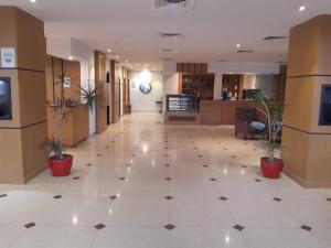 an empty lobby with potted plants in a building at تـالـيـن الـهـفـوف in Al Hofuf