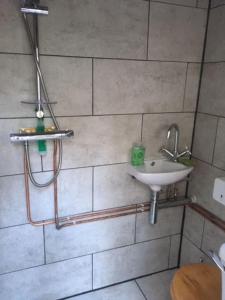 ein Badezimmer mit Waschbecken und Dusche in der Unterkunft Surfers and walkers cosy camping cabin in Ilfracombe