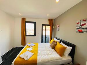a bedroom with a large bed with yellow and white pillows at happy dreams ekonomik otel in Istanbul
