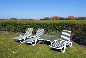 três cadeiras de jardim sentadas na relva num campo em Haus Sonnenperle em Utarp