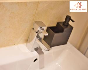 a sink with a faucet in a bathroom at Cosy Contained Riverside 1bed - 2 Floors - Parking in Bridgwater +15 photos