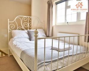 a white bed in a room with a window at Cosy Contained Riverside 1bed - 2 Floors - Parking in Bridgwater