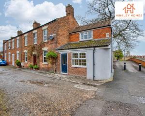 a brick house with a blue door on a street at Cosy Contained Riverside 1bed - 2 Floors - Parking in Bridgwater