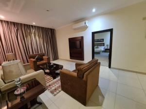 a living room with two couches and a television at تـالـيـن الـهـفـوف in Al Hofuf