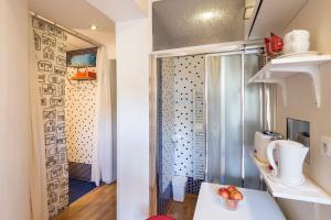 a small bathroom with a shower with a bowl of fruit on a counter at Sleep & Go Single Room in Prague