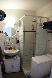 a bathroom with a shower and a sink and a toilet at Studio Marina pointe du bout vue sur le port in Les Trois-Îlets