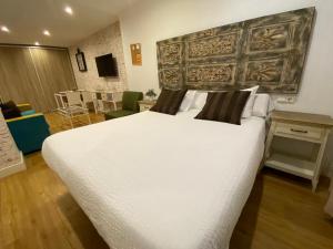 Posteľ alebo postele v izbe v ubytovaní Apartamentos Sevilla Palace