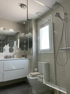 a bathroom with a shower and a toilet and a sink at Marbella Centre with terrace and pool in Marbella