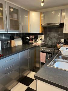 a kitchen with stainless steel cabinets and a sink at Explorers Cottage, Yorkshire Wolds Character Home in Market Weighton