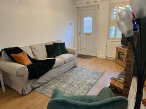 a living room with a couch and a table at Explorers Cottage, Yorkshire Wolds Character Home in Market Weighton