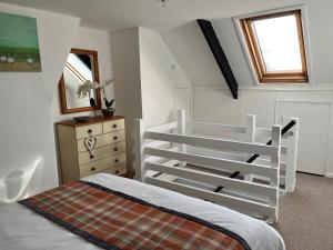 a bedroom with a white bunk bed and a dresser at Explorers Cottage, Yorkshire Wolds Character Home in Market Weighton