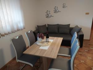 ein Esszimmer mit einem Tisch und einem Sofa in der Unterkunft Apartmány Orava - Zuberec in Zuberec