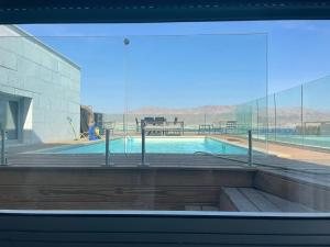 a swimming pool with a view of the desert through a window at villa sea view 100 m from the beach in Eilat