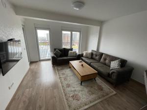 a living room with a couch and a coffee table at ShooTer Apartments in Ferizaj