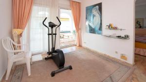 a room with a treadmill and a chair and a window at Villa Vistabella in Chayofa