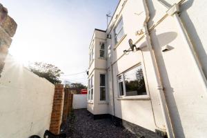 a white building with a window and a satellite at Blue Sky Lodge in Overstrand