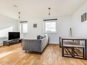 a living room with a couch and a table at Pass the Keys Central Modern Flat with Parking in Chichester