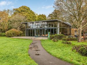 a building with a sign that reads the pavilion at Pass the Keys Central Modern Flat with Parking in Chichester