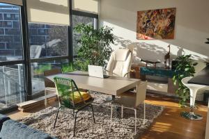 een woonkamer met een tafel en een laptop. bij Luxurious flat sunny, quiet, design, lift, balcony in Londen