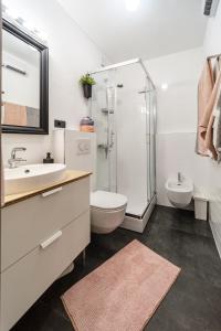 a bathroom with a shower and a toilet and a sink at Apartment Zest in Split