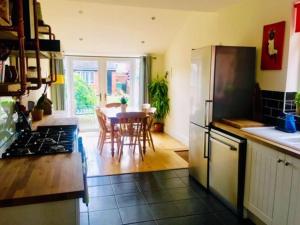 a kitchen with a table and a dining room at Spacious Victorian townhouse with Cathedral views in Lincoln