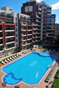 a large swimming pool in front of some apartment buildings at Admiral Plaza in Sunny Beach