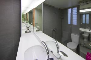 a bathroom with four sinks and a large mirror at Artistic apartment next to everything in Athens