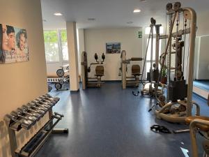 a gym with several treadmills and machines at Ferienapartment Auszeit wie dahoam Am Predigtstuhl in Sankt Englmar