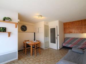 ein kleines Zimmer mit einem Tisch und einem Bett in der Unterkunft Studio cosy au cœur de Briançon avec parking - FR-1-330C-47 in Briançon + 2 Fotos