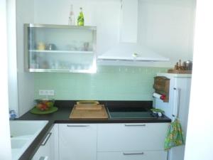 a kitchen with white cabinets and a stove top oven at Appartement Banyuls-sur-Mer, 2 pièces, 4 personnes - FR-1-225C-21 in Banyuls-sur-Mer